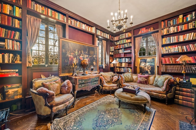 living area featuring dark parquet floors and a chandelier