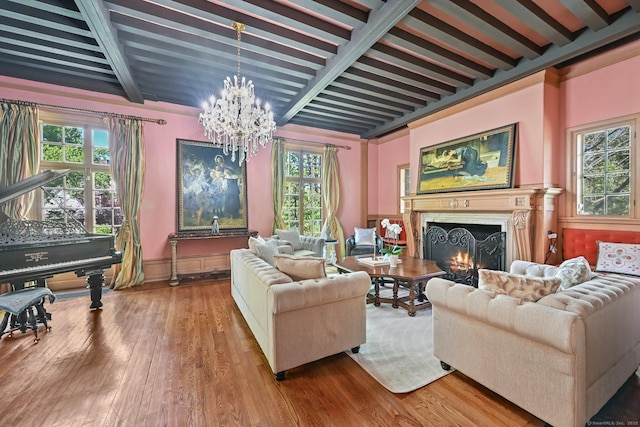 6 Prospect Ct, Hamden, CT 06517 - living area featuring a chandelier, plenty of natural light, beamed ceiling, wood finished floors, and a warm lit fireplace
