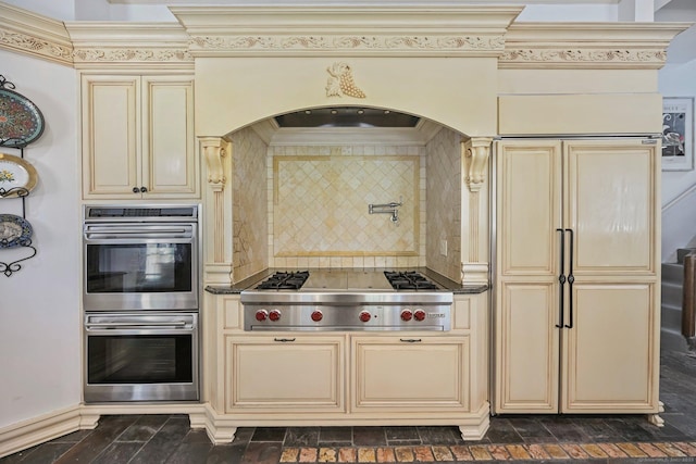 6 Prospect Ct, Hamden, CT 06517 - kitchen with cream cabinetry, stainless steel appliances, crown molding, arched walkways, and tasteful backsplash
