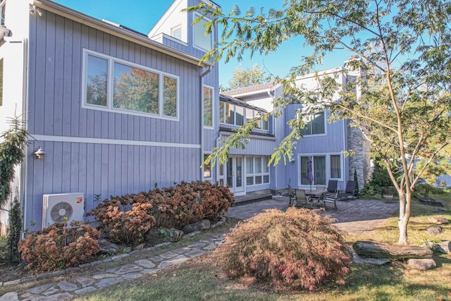 view of front of home with a patio and ac unit