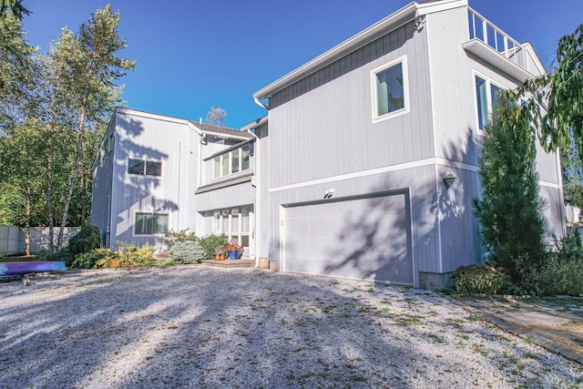 view of side of property with a balcony and a garage