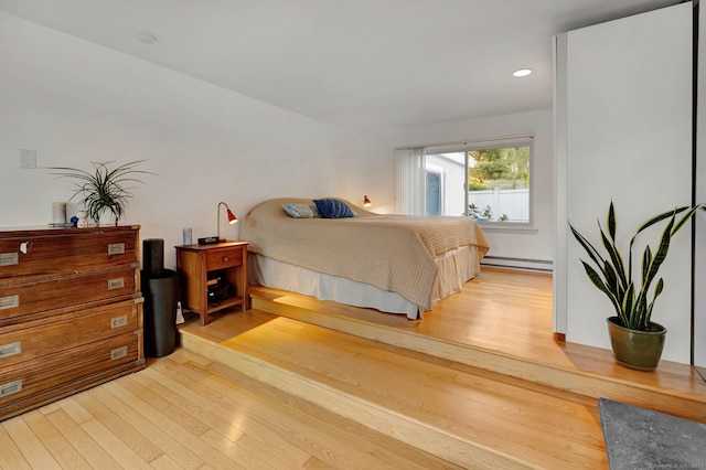 bedroom featuring a baseboard radiator and light wood-type flooring