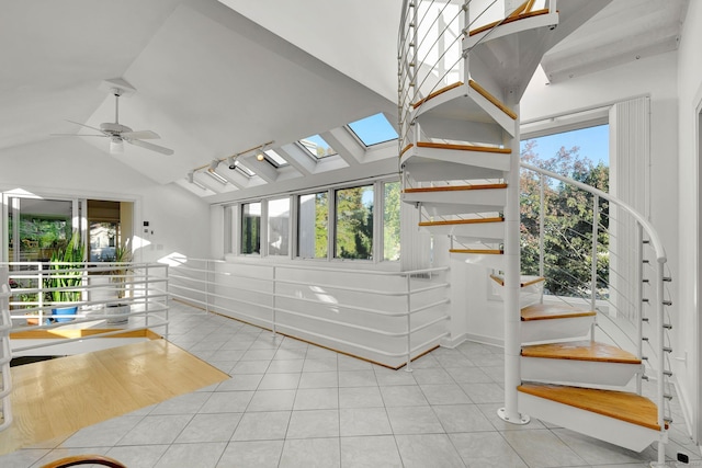 interior space featuring lofted ceiling with skylight, ceiling fan, and plenty of natural light