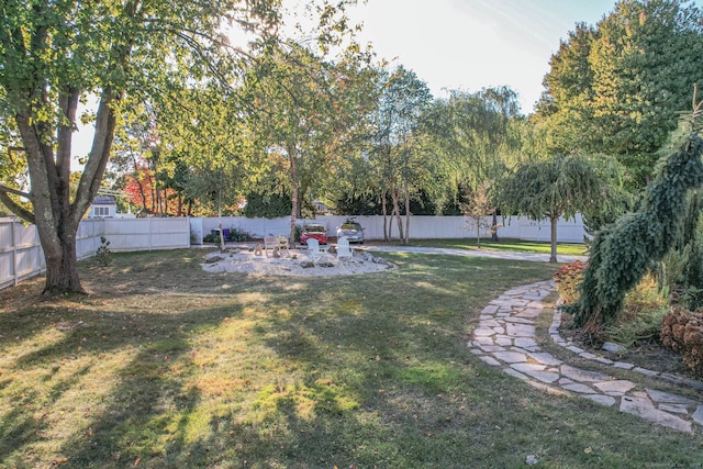 view of yard with a fire pit