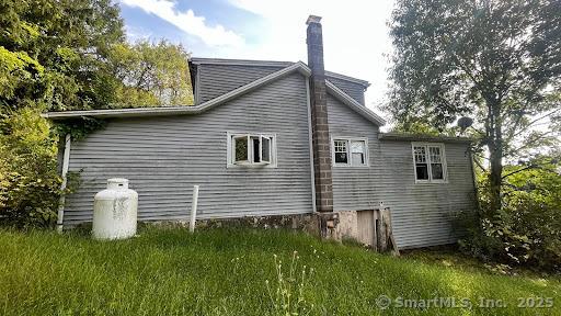 view of side of property with a lawn