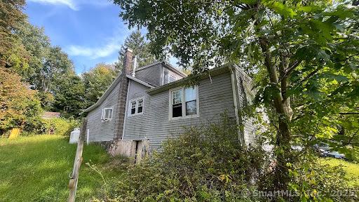 view of side of property featuring a chimney