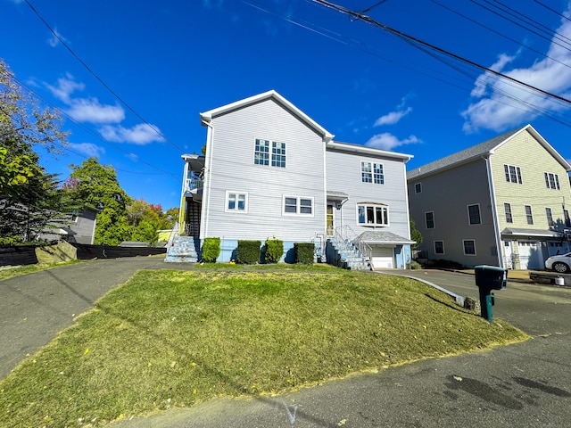 view of front facade with a garage and a front lawn