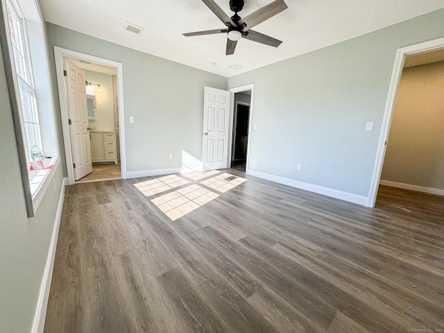 unfurnished bedroom featuring ceiling fan, wood-type flooring, and ensuite bathroom