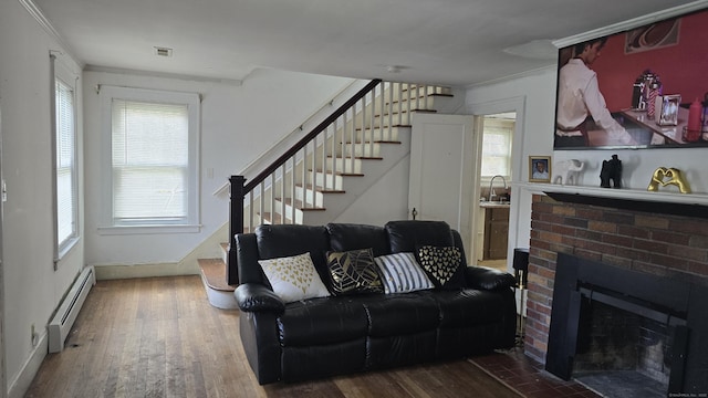 living room with a fireplace, baseboards, stairway, a baseboard heating unit, and hardwood / wood-style flooring