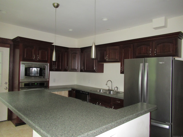 kitchen featuring pendant lighting, stainless steel appliances, sink, and dark brown cabinetry