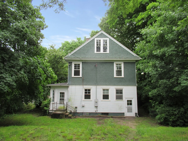 rear view of property with a yard