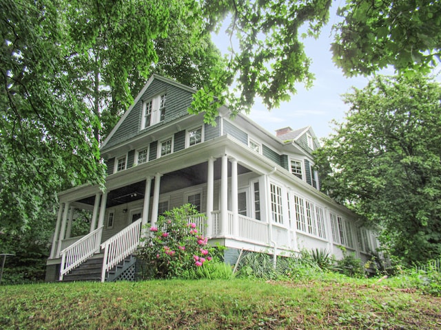 view of front of house with a porch and a sunroom