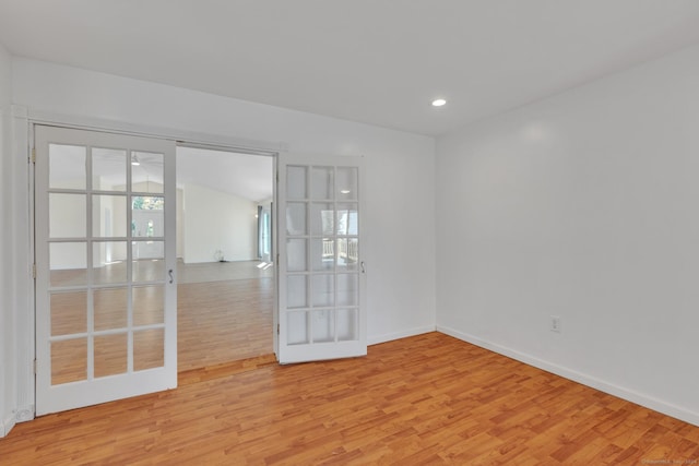 spare room with french doors and light wood-type flooring