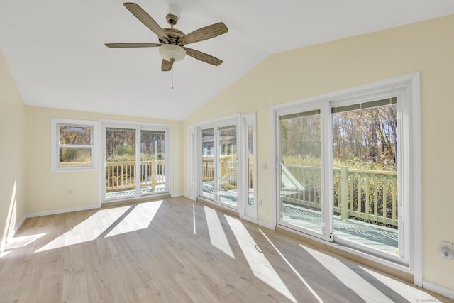 unfurnished sunroom with ceiling fan and vaulted ceiling