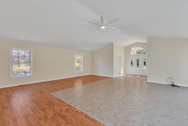 unfurnished living room with light tile patterned floors, ceiling fan, and lofted ceiling