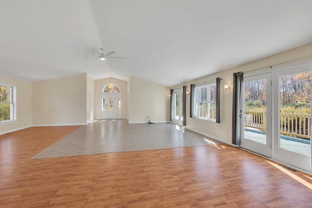 spare room with light hardwood / wood-style floors, vaulted ceiling, and plenty of natural light