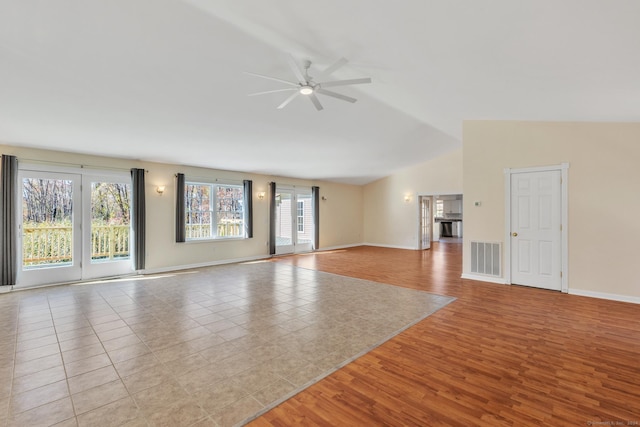 unfurnished living room with ceiling fan, light hardwood / wood-style flooring, and lofted ceiling