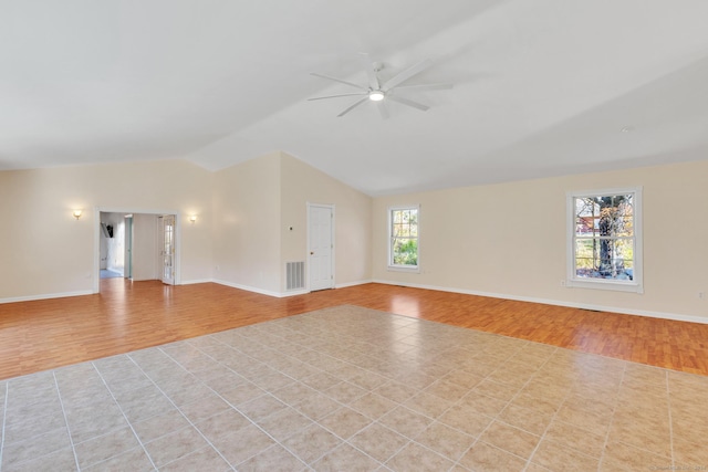 spare room with ceiling fan, lofted ceiling, and light wood-type flooring