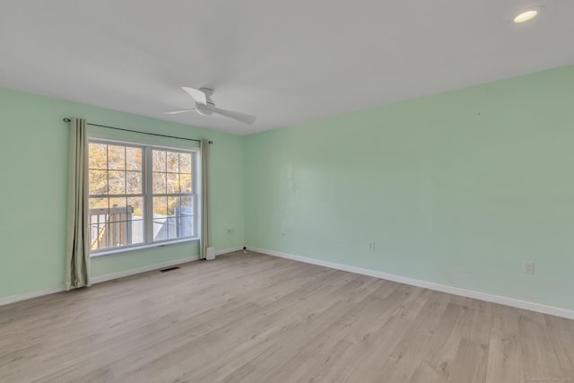 empty room with ceiling fan and light wood-type flooring