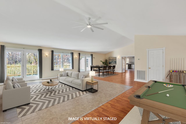 living room with light wood-type flooring, vaulted ceiling, ceiling fan, and billiards