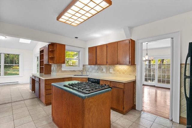 kitchen featuring a healthy amount of sunlight, decorative backsplash, and a center island