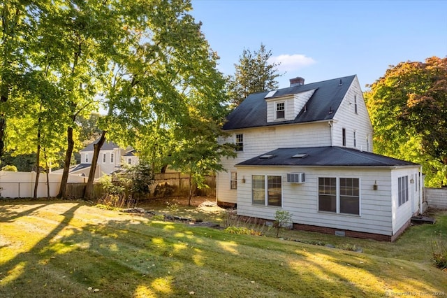 back of house with a lawn and a wall mounted air conditioner