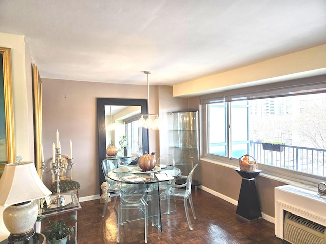 dining room with dark parquet floors and heating unit