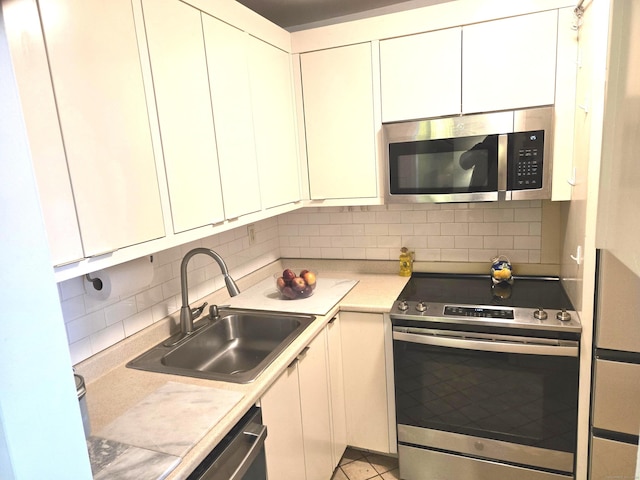 kitchen with white cabinets, appliances with stainless steel finishes, and sink