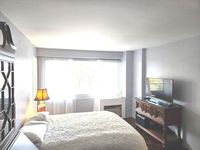 bedroom with dark wood-type flooring