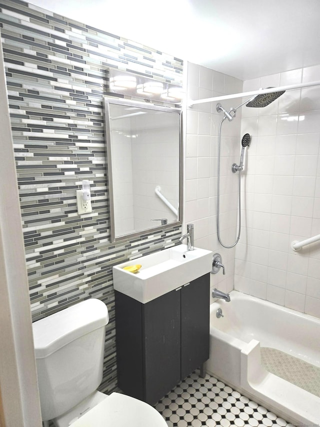 full bathroom featuring tasteful backsplash, vanity, tile walls, toilet, and tiled shower / bath