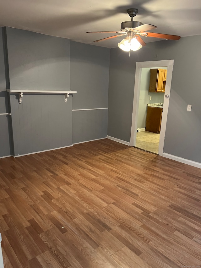 spare room with hardwood / wood-style flooring and ceiling fan