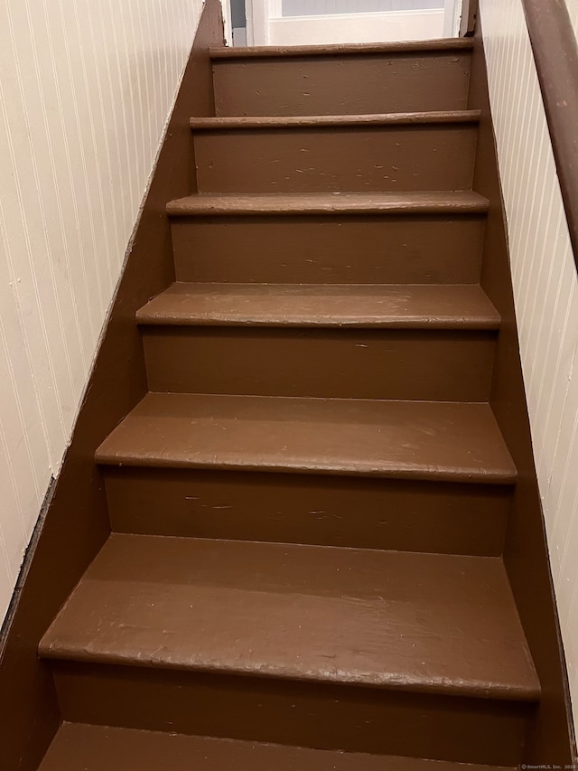 stairway with wood walls