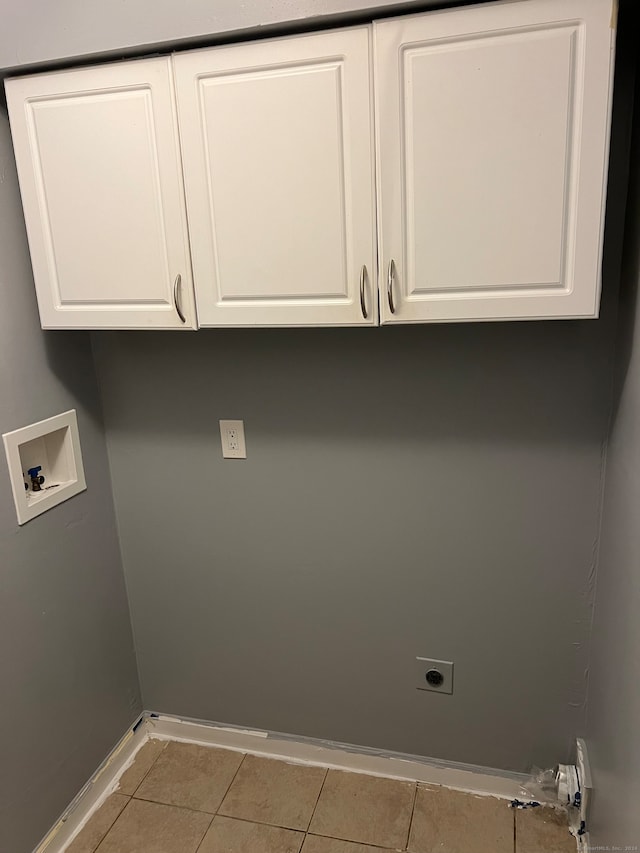 laundry area with light tile patterned flooring, washer hookup, hookup for an electric dryer, and cabinets