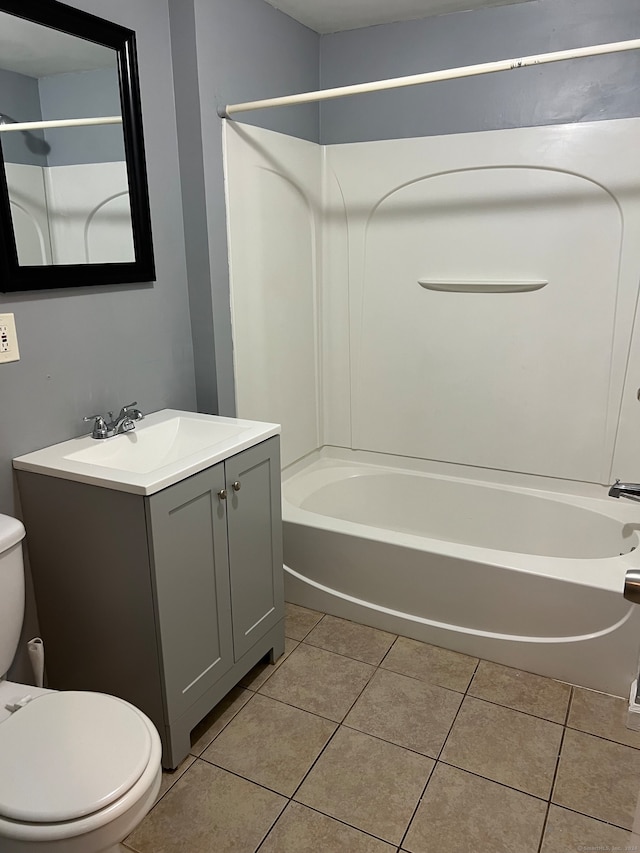 full bathroom featuring  shower combination, vanity, tile patterned flooring, and toilet