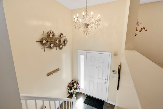 tiled entryway featuring a chandelier