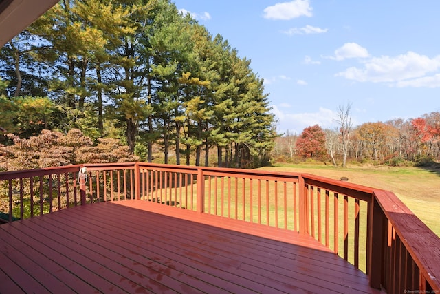 wooden terrace featuring a yard