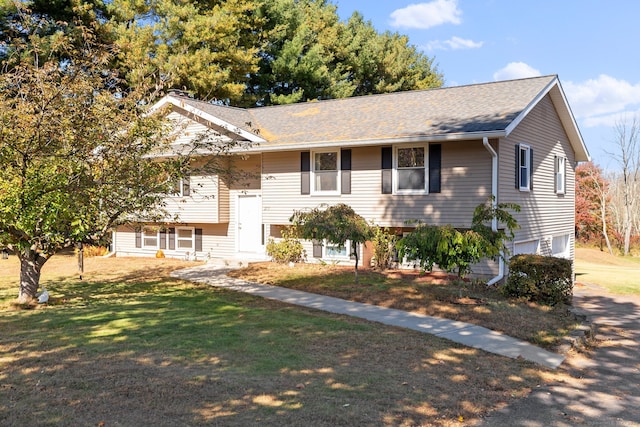 bi-level home with a front lawn