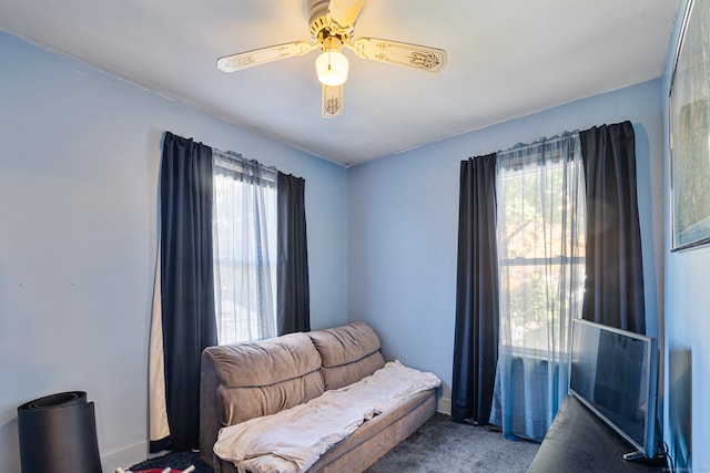 sitting room featuring ceiling fan and carpet flooring