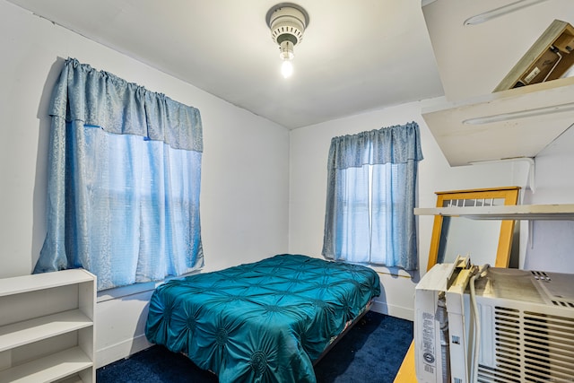 bedroom with dark colored carpet