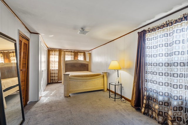 bedroom featuring a closet, ornamental molding, and carpet floors