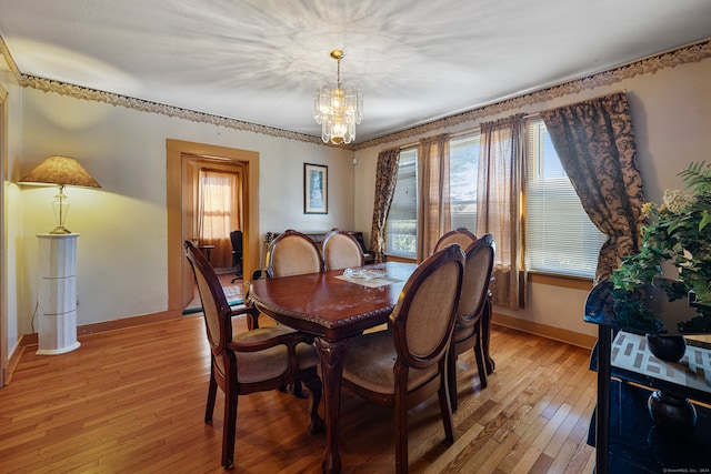 dining room featuring light hardwood / wood-style floors and a chandelier