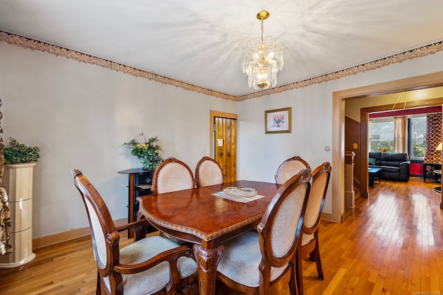 dining space with a chandelier and light wood-type flooring