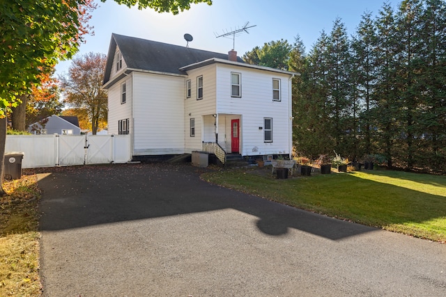 colonial home with a front lawn