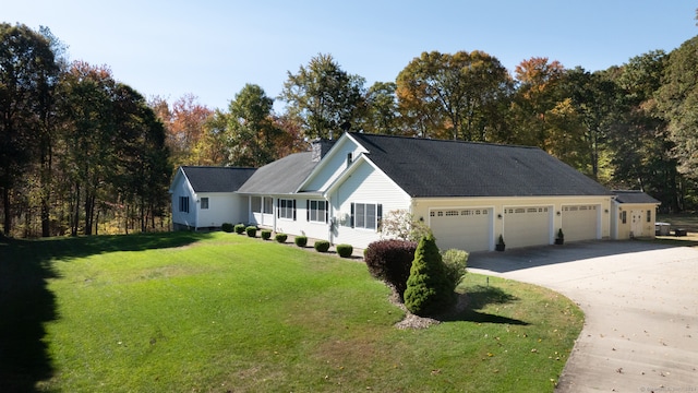 view of front facade with a front yard and a garage