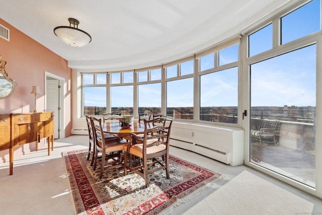 sunroom featuring baseboard heating and a wealth of natural light