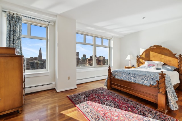 bedroom featuring light hardwood / wood-style flooring and a baseboard radiator