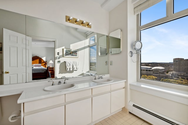 bathroom featuring vanity, a wealth of natural light, and baseboard heating