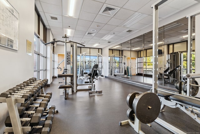 workout area with a paneled ceiling