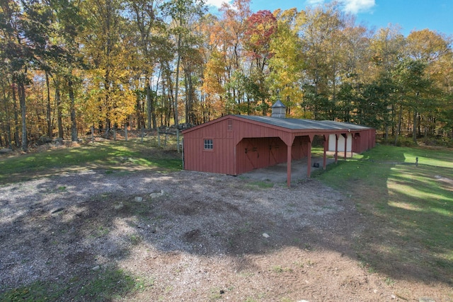 view of outbuilding featuring a lawn