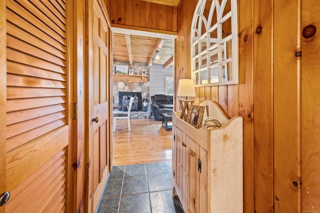 hall with wood walls and dark wood-type flooring